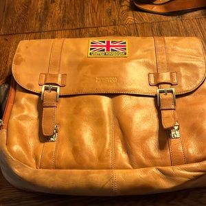 Kenneth Cole slight faded vintage look . some spots from another leather bag.